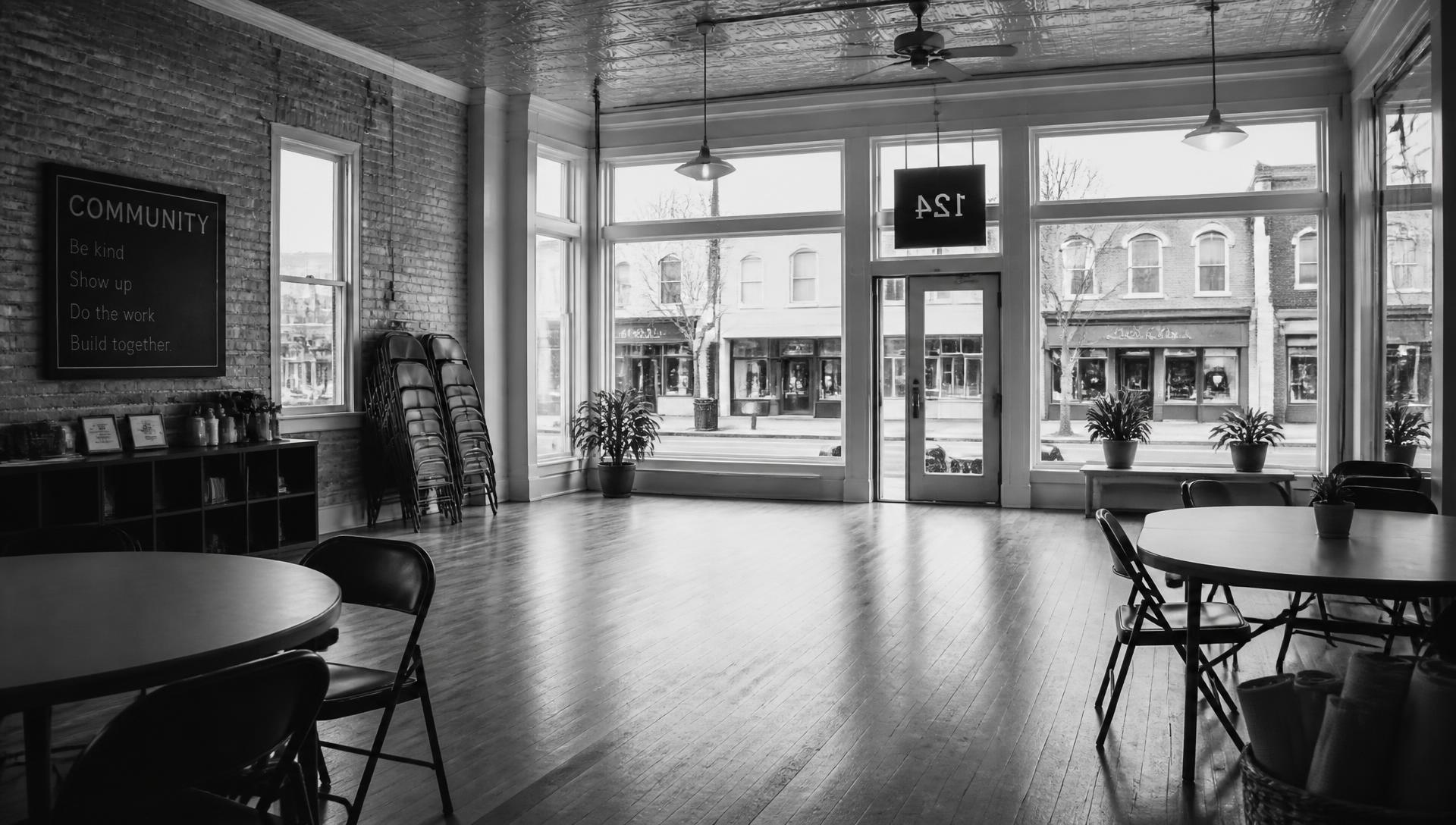 Interior of The Commons with wood floors, brick walls and storefront windows